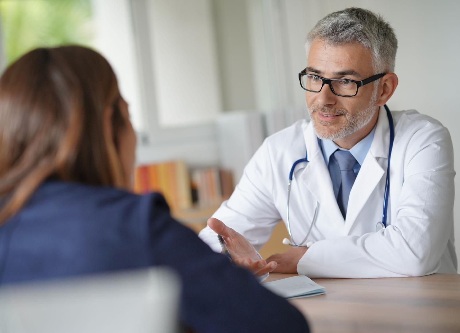 Doctor with a patient sitting at a table